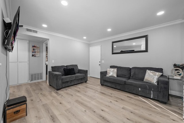 living room with crown molding and light hardwood / wood-style flooring