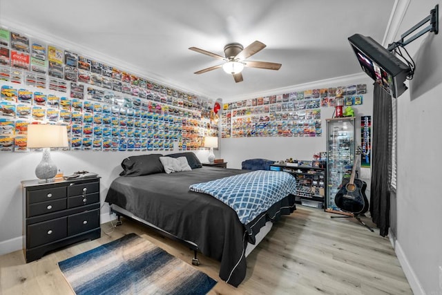 bedroom featuring ceiling fan, wood-type flooring, and crown molding