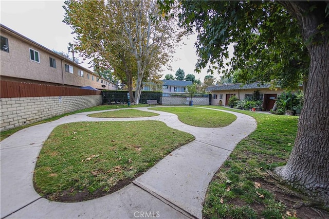 view of property's community with a lawn