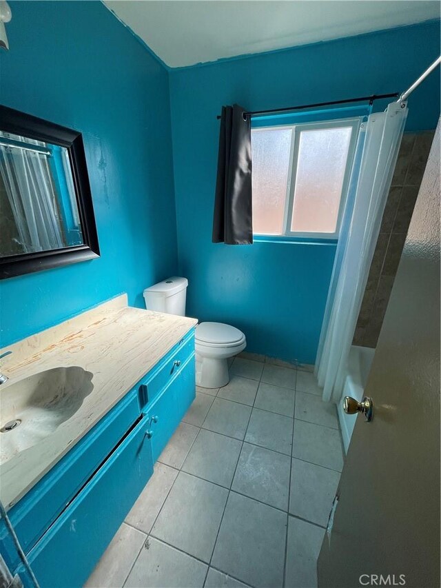 full bathroom featuring vanity, shower / tub combo, tile patterned floors, and toilet