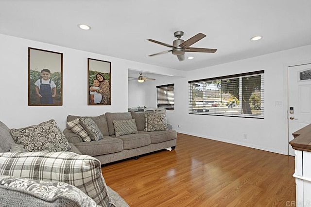 living room featuring hardwood / wood-style flooring and ceiling fan