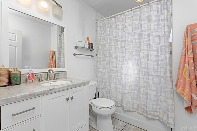 full bathroom with vanity, toilet, and shower / bath combo with shower curtain