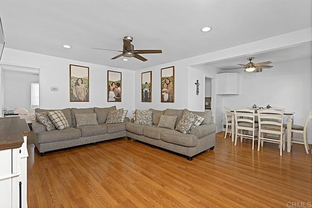 living room with ceiling fan and light hardwood / wood-style floors