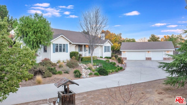 single story home with a garage and an outdoor structure