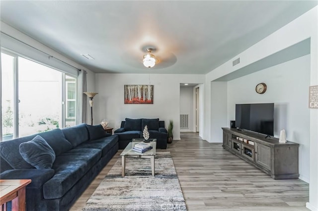 living room with ceiling fan and light hardwood / wood-style floors