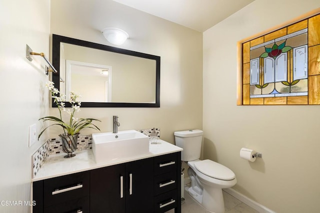 bathroom with tile patterned flooring, vanity, and toilet