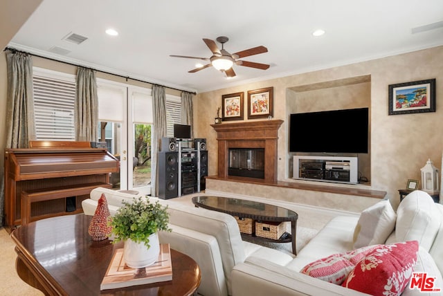 living room featuring ceiling fan and ornamental molding