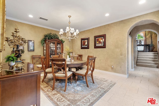 dining space featuring ornamental molding and an inviting chandelier