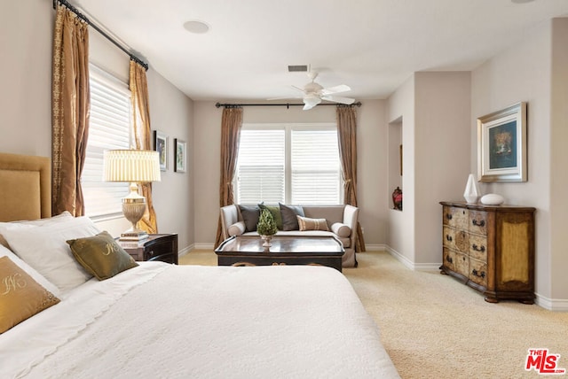 bedroom with ceiling fan and light carpet