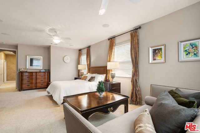 bedroom featuring ceiling fan and light carpet