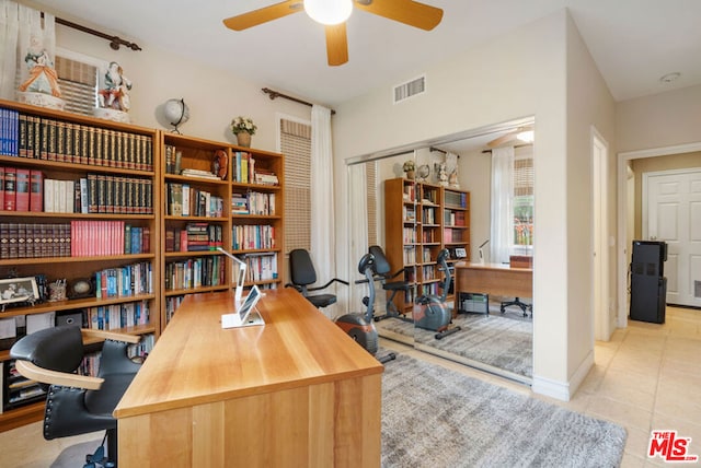 tiled office featuring ceiling fan