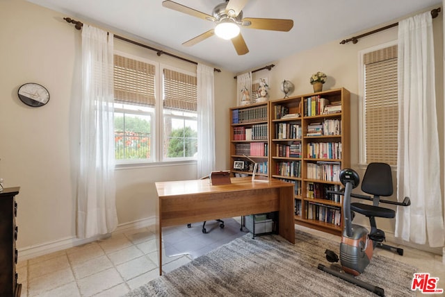 tiled office featuring ceiling fan