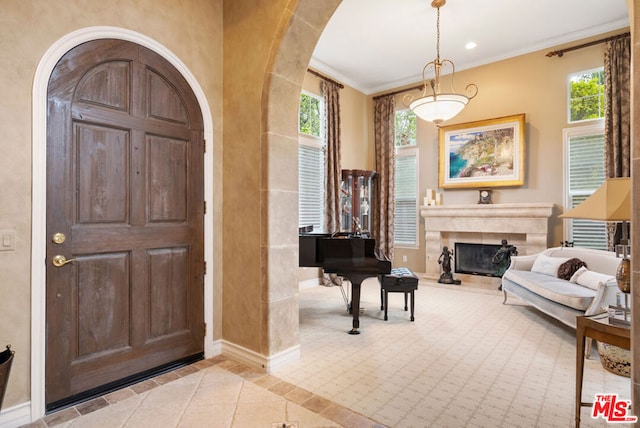 entrance foyer with ornamental molding and light tile patterned flooring