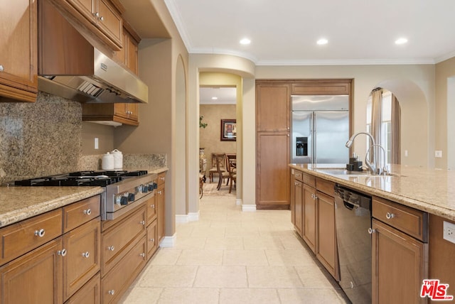 kitchen featuring light stone counters, sink, stainless steel appliances, and crown molding