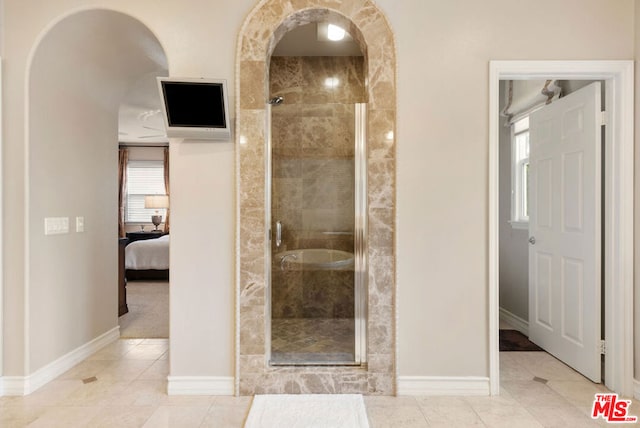 bathroom featuring tile patterned flooring and an enclosed shower