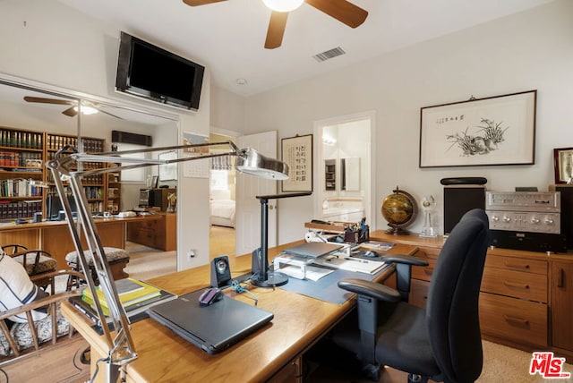 carpeted office with lofted ceiling