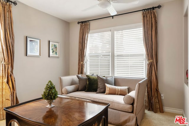 living room with light carpet and ceiling fan