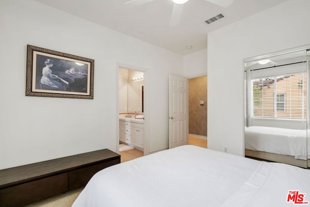 carpeted bedroom with ceiling fan and ensuite bathroom