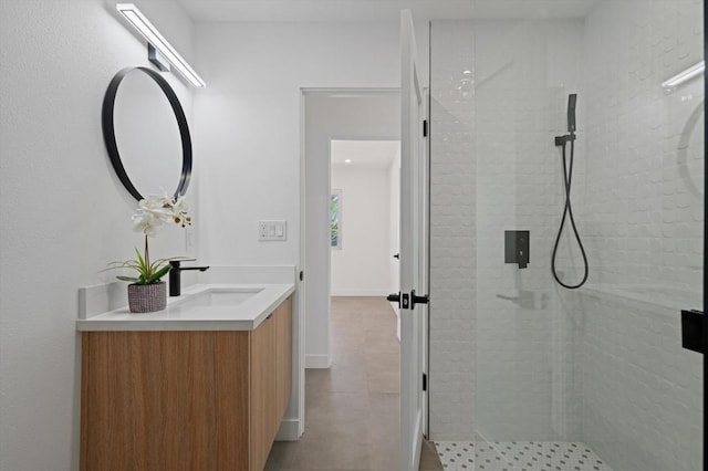 bathroom with vanity and a tile shower