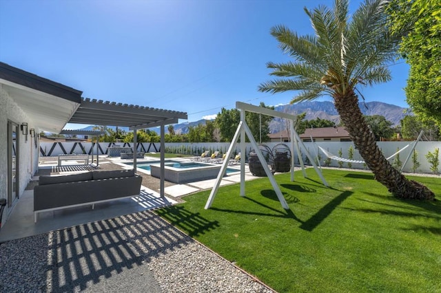 view of jungle gym featuring a swimming pool with hot tub, a lawn, a pergola, a patio area, and a mountain view