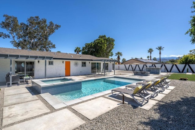 view of swimming pool with a patio and an in ground hot tub