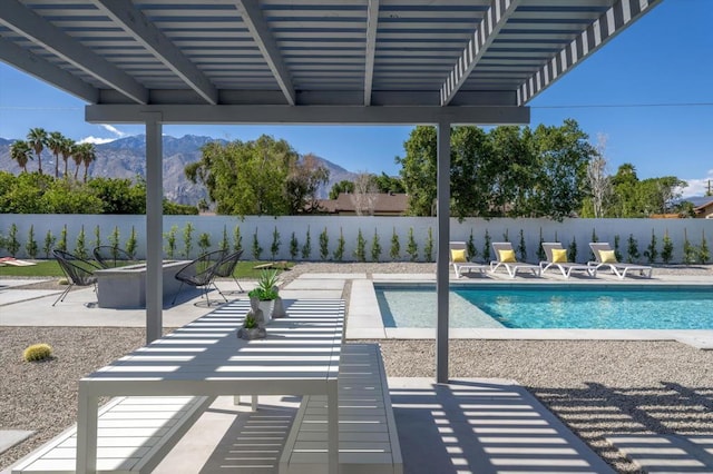 view of pool featuring an outdoor fire pit, a mountain view, and a patio area