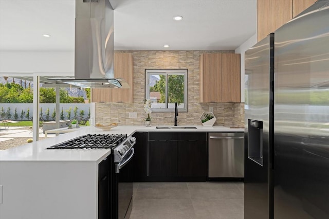 kitchen featuring sink, island range hood, decorative backsplash, and appliances with stainless steel finishes