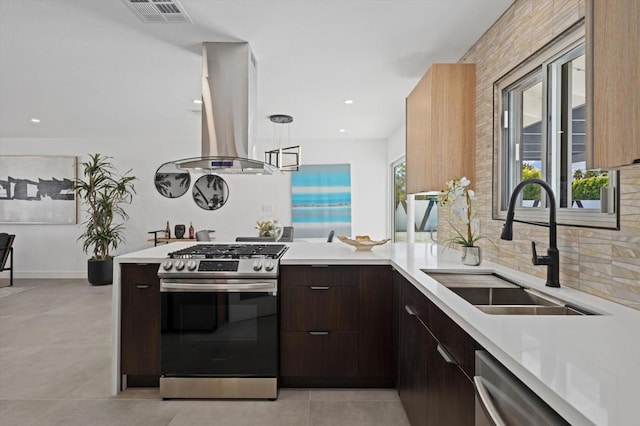 kitchen featuring dark brown cabinetry, sink, island exhaust hood, and appliances with stainless steel finishes