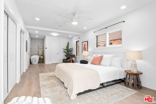 bedroom featuring light wood-type flooring and ceiling fan