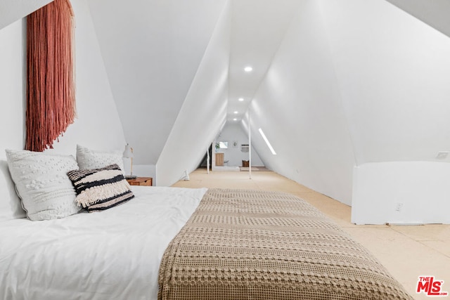 bedroom featuring light colored carpet and vaulted ceiling