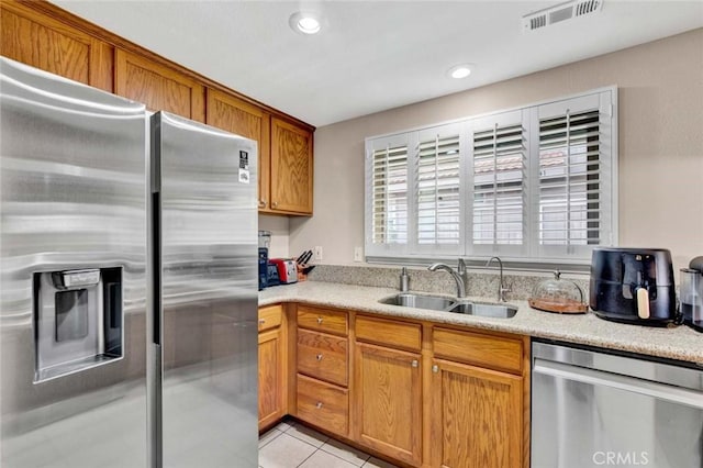 kitchen featuring light tile patterned flooring, sink, and appliances with stainless steel finishes