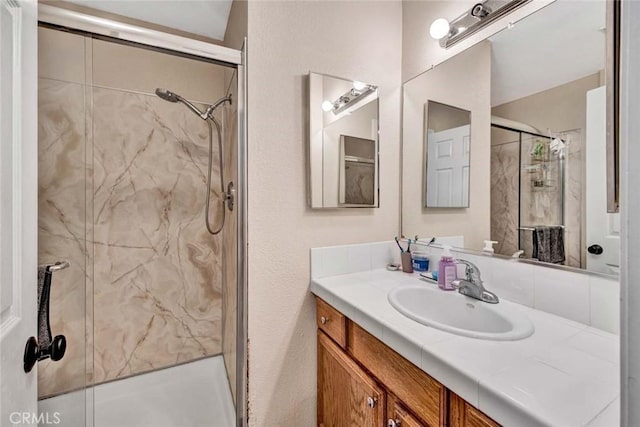 bathroom with vanity and a shower with shower door