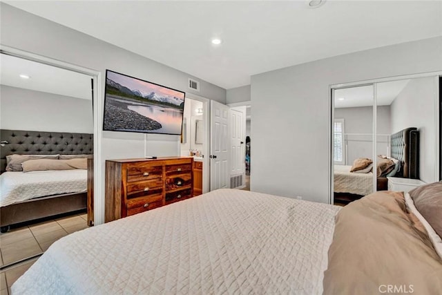 bedroom with radiator, a closet, and light tile patterned flooring