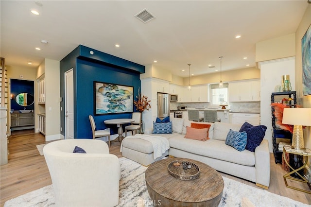 living room with light hardwood / wood-style flooring