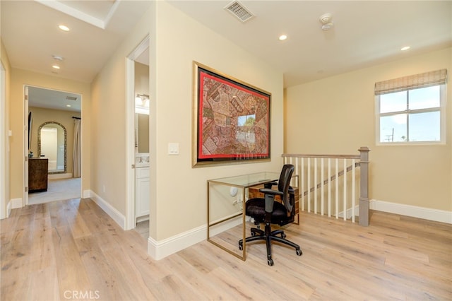 office with light hardwood / wood-style floors