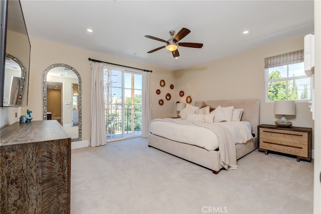 carpeted bedroom featuring access to outside, multiple windows, and ceiling fan