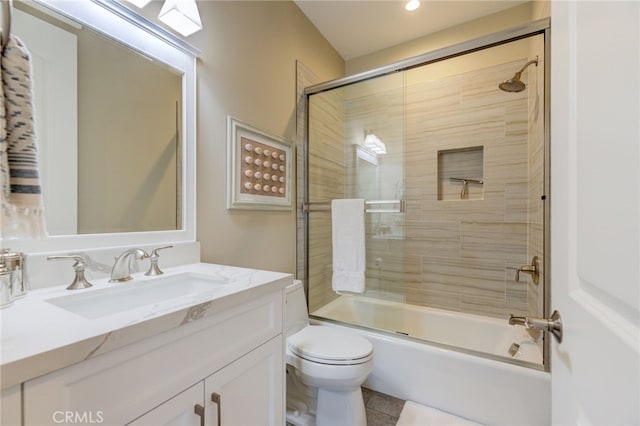 full bathroom with tile patterned floors, vanity, toilet, and enclosed tub / shower combo