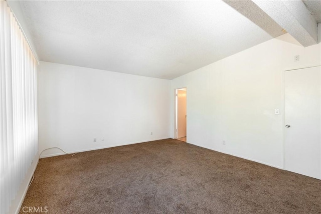 empty room with lofted ceiling and carpet floors