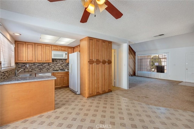 kitchen featuring white appliances, light carpet, sink, backsplash, and ceiling fan