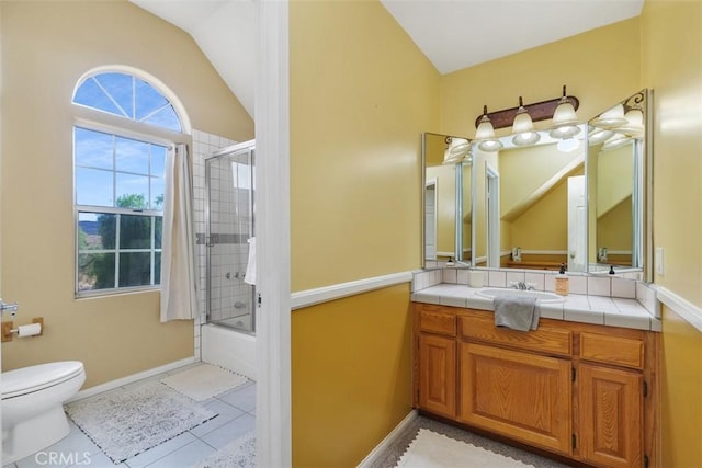 full bathroom featuring toilet, bath / shower combo with glass door, tile patterned flooring, vaulted ceiling, and vanity