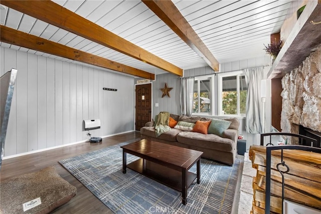 living room featuring dark wood-type flooring and beam ceiling