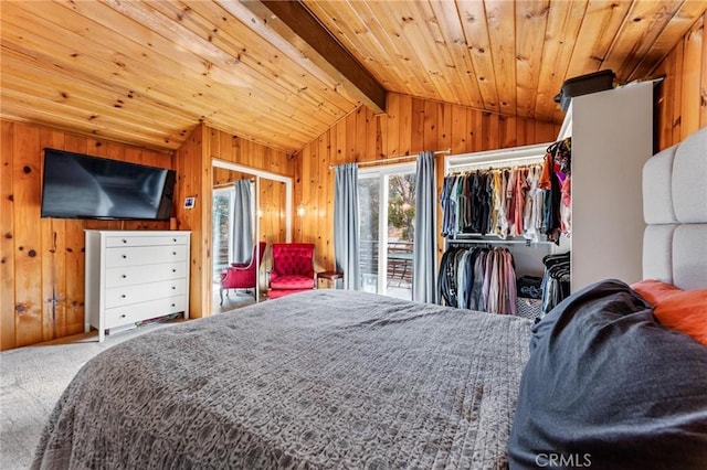 carpeted bedroom with access to outside, lofted ceiling with beams, and wooden walls