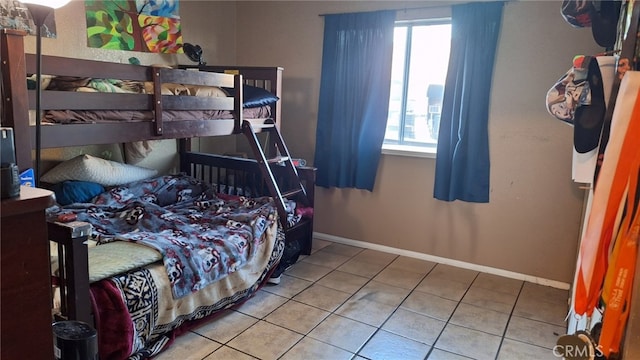 6100 Rugby Ave Unit 207, Huntington Park, CA 90255 - bedroom with multiple windows, tile patterned flooring, and baseboards