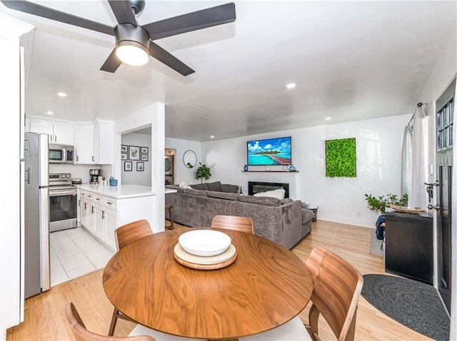 dining space featuring ceiling fan and light hardwood / wood-style flooring