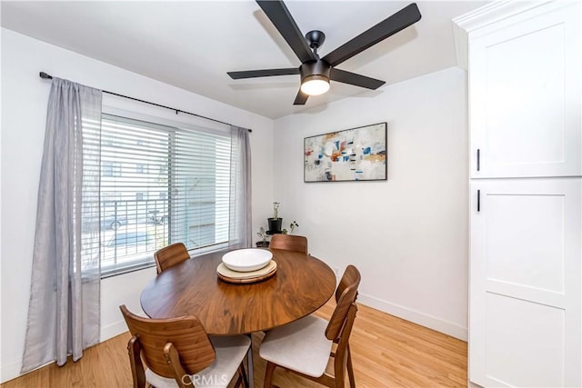 dining area with ceiling fan and light hardwood / wood-style floors