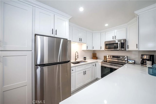 kitchen featuring white cabinets, sink, and stainless steel appliances