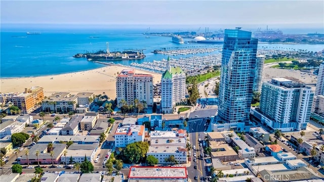 birds eye view of property featuring a water view and a beach view