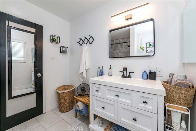 bathroom featuring tile patterned floors, vanity, and walk in shower