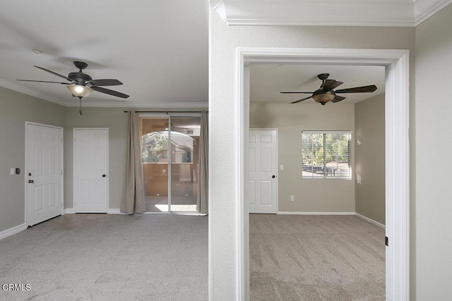 unfurnished room featuring ceiling fan, ornamental molding, and light carpet