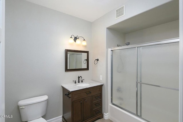 full bathroom featuring shower / bath combination with glass door, vanity, and toilet